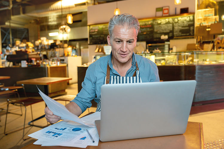 Small business owner looking at legal documents
